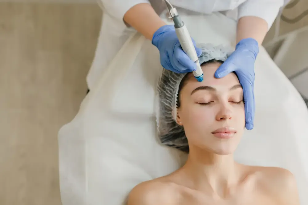 Hydrafacial device handpiece being used on facial skin in London clinic